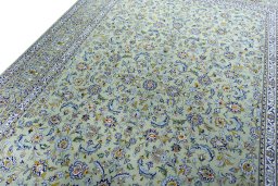 Backside of handmade 2000s Kashan rug showing knot structure and weave density