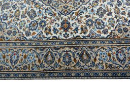 Corner detail of 2000s Kashan rug showing border pattern and Wool pile