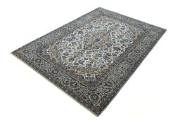 Corner detail of 2000s Kashan rug showing border pattern and Wool pile