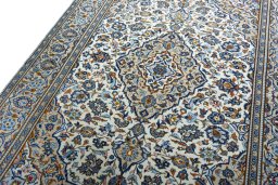 Backside of handmade 2000s Kashan rug showing knot structure and weave density