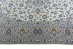 Corner detail of 2000s Kashan rug showing border pattern and Wool pile