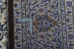 Backside of handmade 2000s Kashan rug showing knot structure and weave density