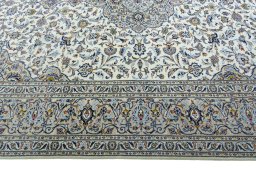 Corner detail of 2000s Kashan rug showing border pattern and Wool pile