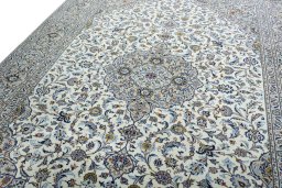 Backside of handmade 2000s Kashan rug showing knot structure and weave density