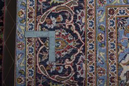 Backside of handmade 2000s Kashan rug showing knot structure and weave density