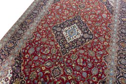 Backside of handmade 2000s Kashan rug showing knot structure and weave density