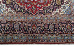 Full view of 2000s Kashan rug from Iran / Persia, 322 × 197 cm in Red tones