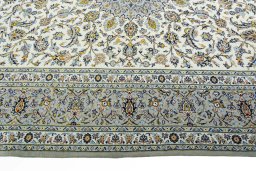 Corner detail of 2000s Kashan rug showing border pattern and Wool pile