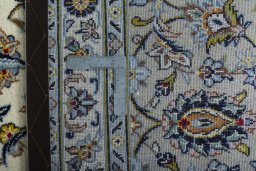 Backside of handmade 2000s Kashan rug showing knot structure and weave density