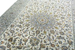 Backside of handmade 2000s Kashan rug showing knot structure and weave density