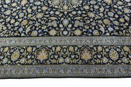 Corner detail of 2000s Kashan rug showing border pattern and Wool pile