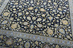 Close-up detail of 2000s Kashan rug from Iran / Persia showing Wool weave