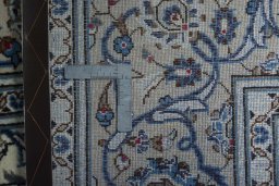 Backside of handmade 2000s Kashan rug showing knot structure and weave density