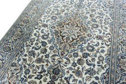 Backside of handmade 2000s Kashan rug showing knot structure and weave density