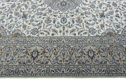 Corner detail of 2000s Kashan rug showing border pattern and Wool pile