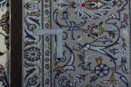 Backside of handmade 2000s Kashan rug showing knot structure and weave density