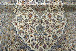 Corner detail of 2000s Kashan rug showing border pattern and Wool pile