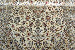 Corner detail of 2000s Kashan rug showing border pattern and Wool pile