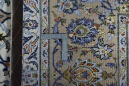 Backside of handmade 2000s Kashan rug showing knot structure and weave density