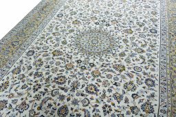 Backside of handmade 2000s Kashan rug showing knot structure and weave density