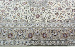 Corner detail of 2000s Kashan rug showing border pattern and Wool pile