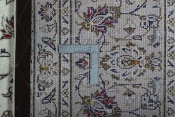 Backside of handmade 2000s Kashan rug showing knot structure and weave density