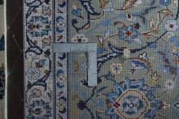 Backside of handmade 1970s Kashan rug showing knot structure and weave density