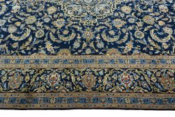 Corner detail of 2000s Kashan rug showing border pattern and Wool pile