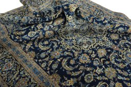 Surface texture of 2000s Kashan rug with natural Wool and intricate pattern