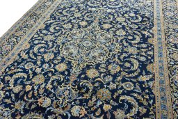 Backside of handmade 2000s Kashan rug showing knot structure and weave density