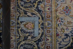 Backside of handmade 1970s Kashan rug showing knot structure and weave density