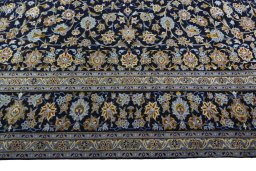 Corner detail of 2000s Kashan rug showing border pattern and Wool pile