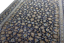 Backside of handmade 2000s Kashan rug showing knot structure and weave density