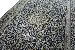 Backside of handmade 2000s Kashan rug showing knot structure and weave density