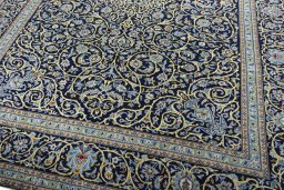 Close-up detail of 2000s Kashan rug from Iran / Persia showing Wool weave