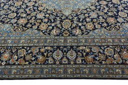 Corner detail of 2000s Kashan rug showing border pattern and Wool pile