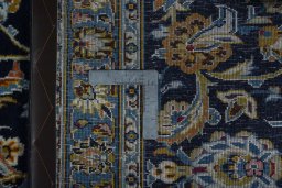 Backside of handmade 2000s Kashan rug showing knot structure and weave density