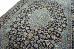 Backside of handmade 2000s Kashan rug showing knot structure and weave density
