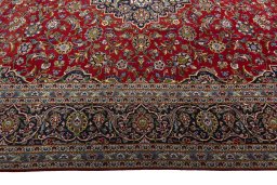 Corner detail of 2000s Kashan rug showing border pattern and Wool pile