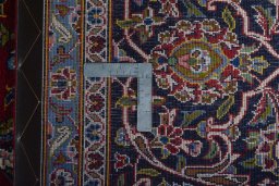Backside of handmade 2000s Kashan rug showing knot structure and weave density