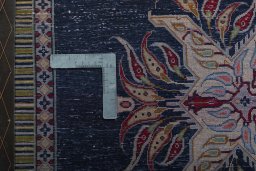 Backside of handmade 2000s Kashan rug showing knot structure and weave density