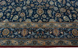 Corner detail of 2000s Kashan rug showing border pattern and Wool pile