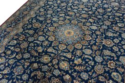 Backside of handmade 2000s Kashan rug showing knot structure and weave density