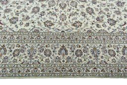 Corner detail of 2000s Kashan rug showing border pattern and Wool pile