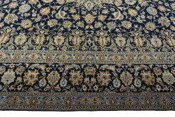 Corner detail of 2000s Kashan rug showing border pattern and Wool pile