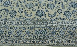 Corner detail of 2000s Kashan rug showing border pattern and Wool pile