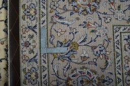Backside of handmade 2000s Kashan rug showing knot structure and weave density
