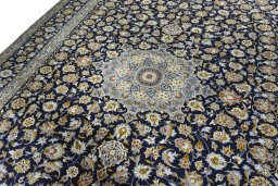 Backside of handmade 2000s Kashan rug showing knot structure and weave density