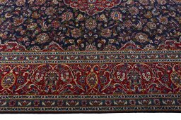 Corner detail of 2000s Kashan rug showing border pattern and Wool pile