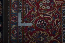 Backside of handmade 2000s Kashan rug showing knot structure and weave density